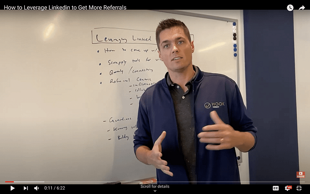 In front of a whiteboard brimming with handwritten notes, an expert outlines actionable LinkedIn strategies to maximize valuable referrals.